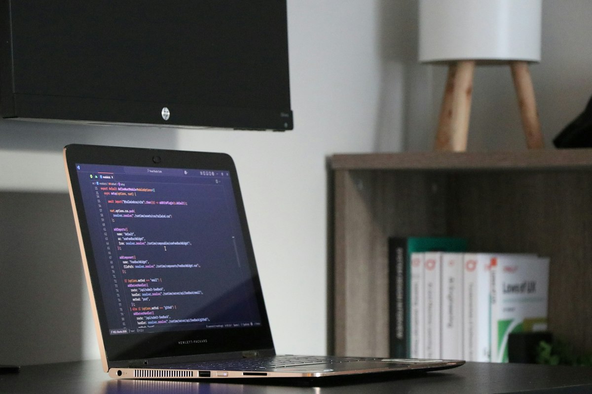 A laptop open to a screen of code on a desk